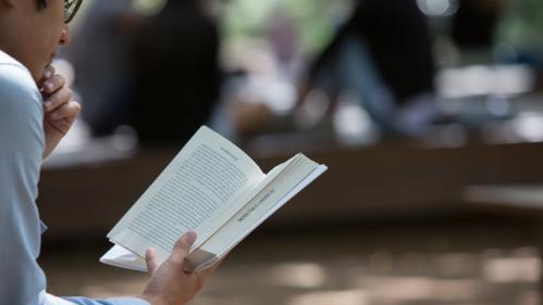 Student reading on campus