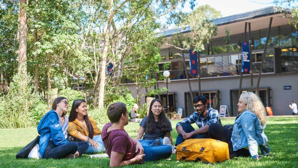 Students on duck pond lawn