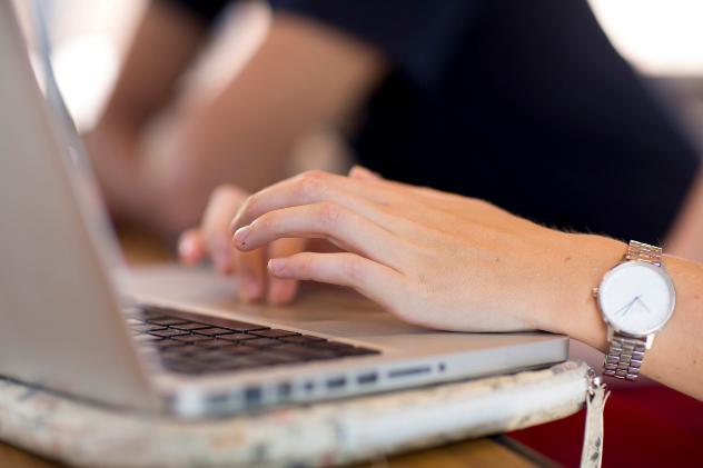 An open laptop is being used by a student