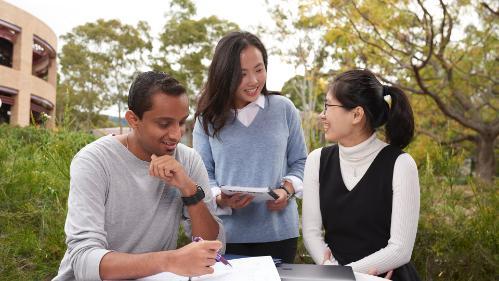 Chinese students and indian student at table near Building 36