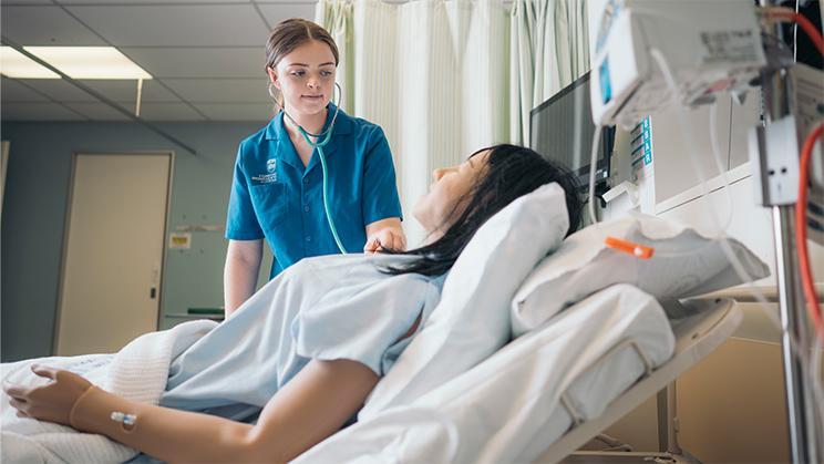UOW Nursing student practices using a stethoscope