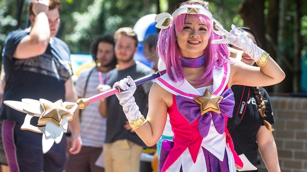 A UOW student on the lawn in a cosplay costume