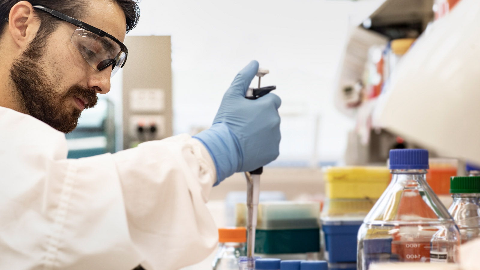 Medical science student conducting lab experiment holding test samples