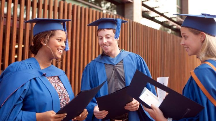 Group of graduates with documents