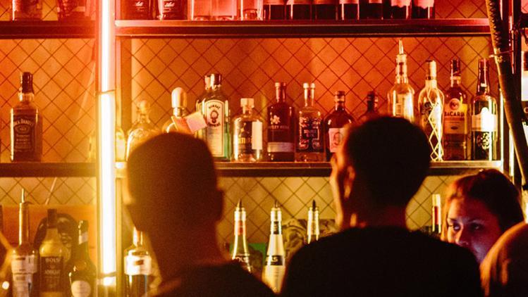 Image of two people sitting at a bar