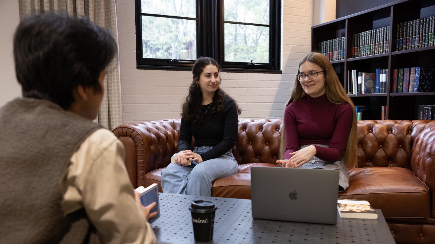 Students sitting around a table conversing