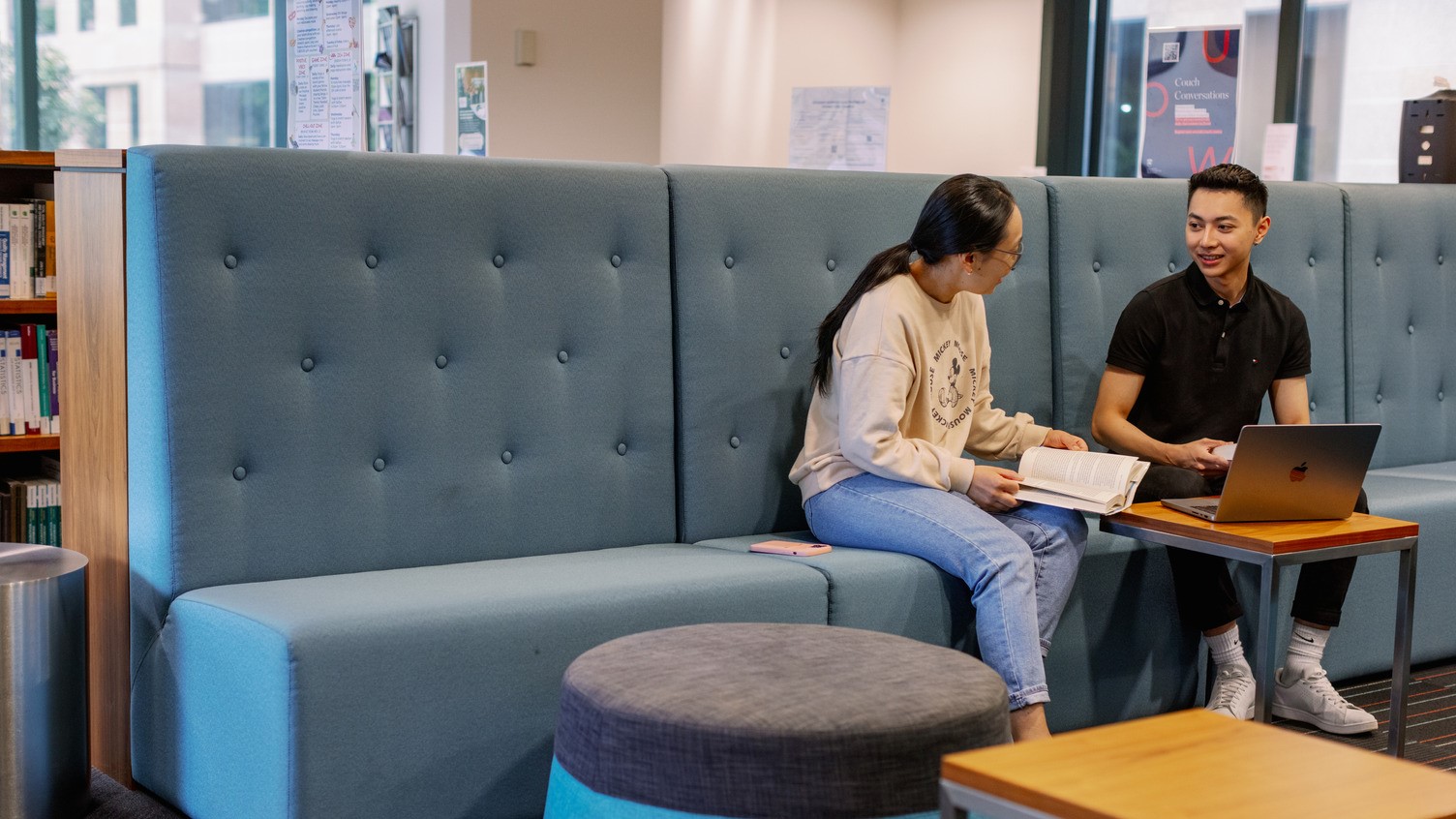UOW Liverpool students sitting at a couch having a conversation