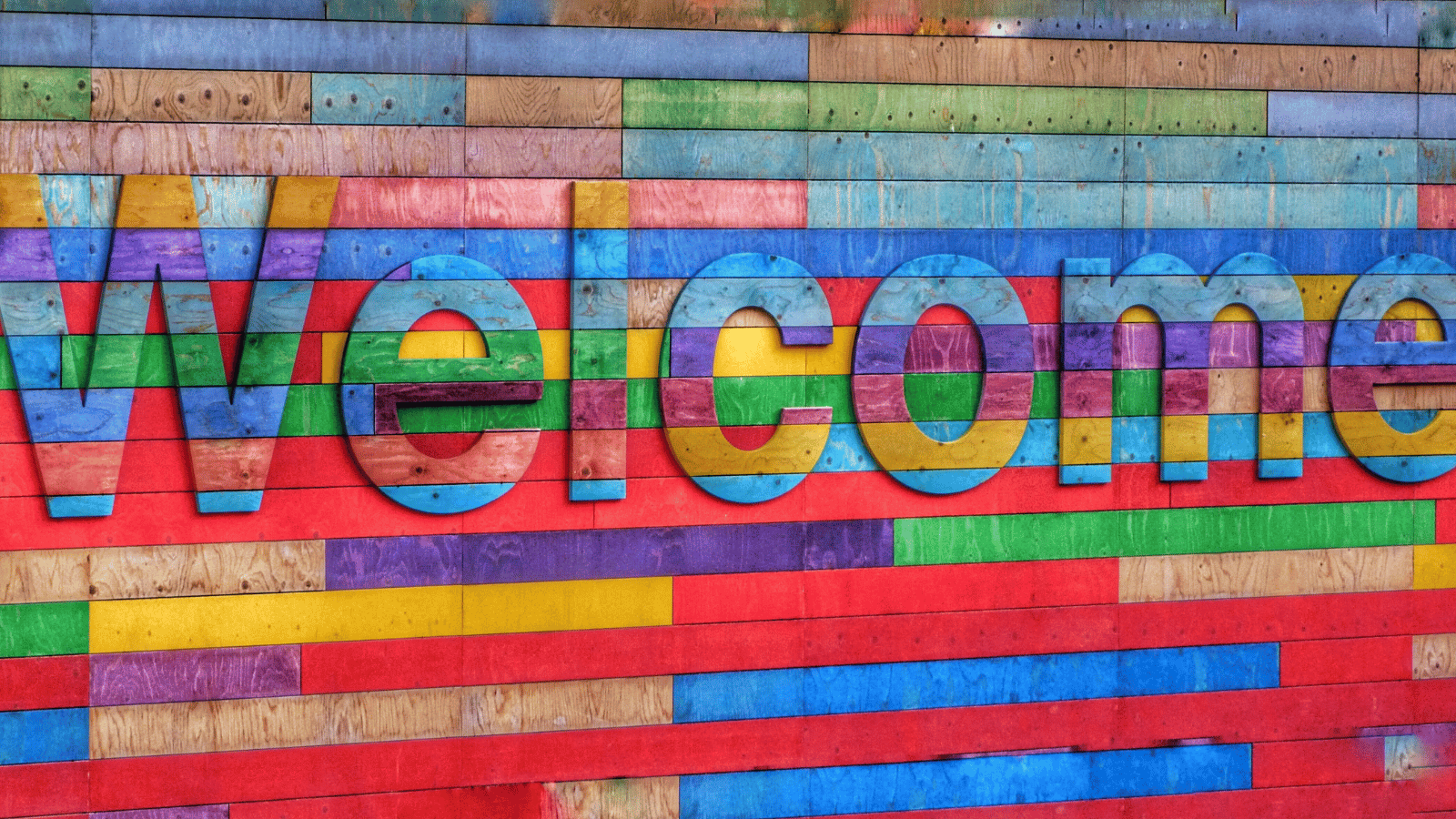 A colourful wooden sign with the word 