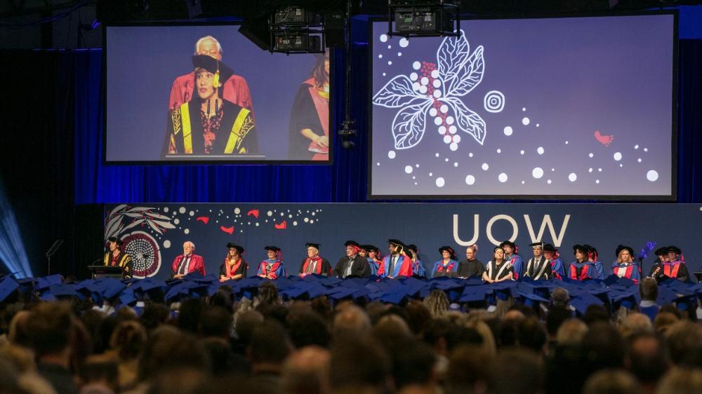 Back of audience heads looking at 2023 UOW Graduation ceremony