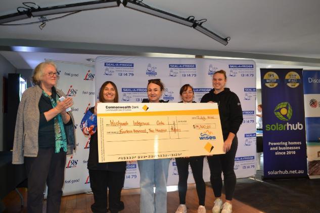 WIC staff accepting donation cheque at Uncle Decky Day