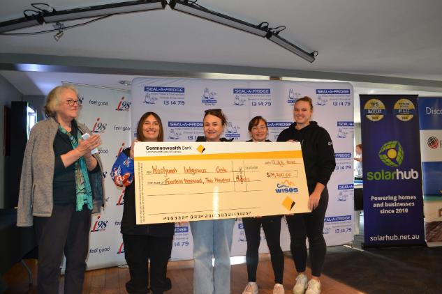 WIC staff accepting donation cheque at Uncle Decky Day