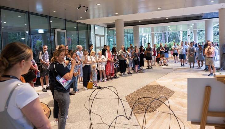 Many people. Staff and guests. Stand in the atrium of building 29.