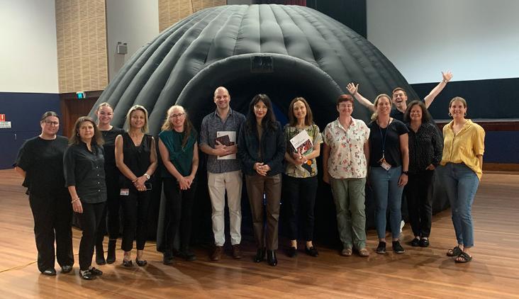 A group of UOW staff and guests stand infront of the inflatable GeoDome