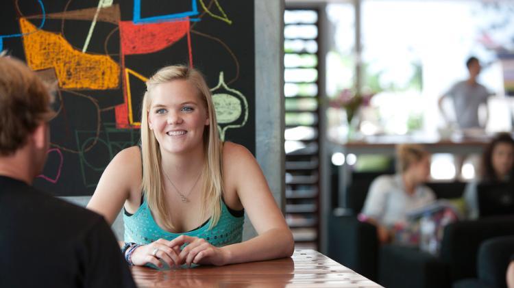 Girl sitting at table talking