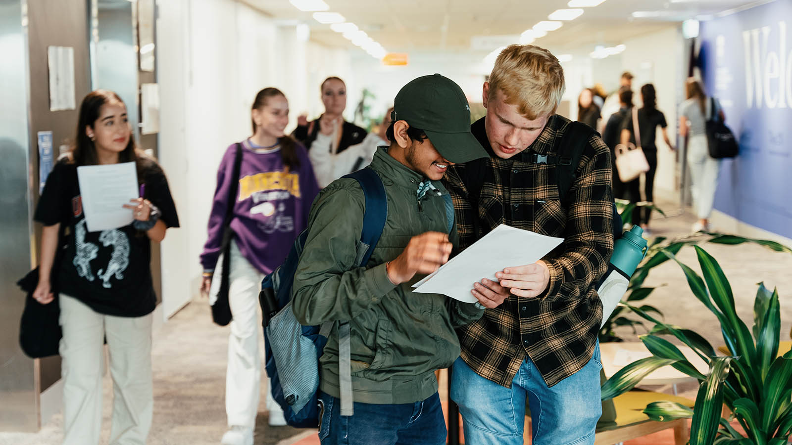Two students check information during Orientation at UOW Liverpool.