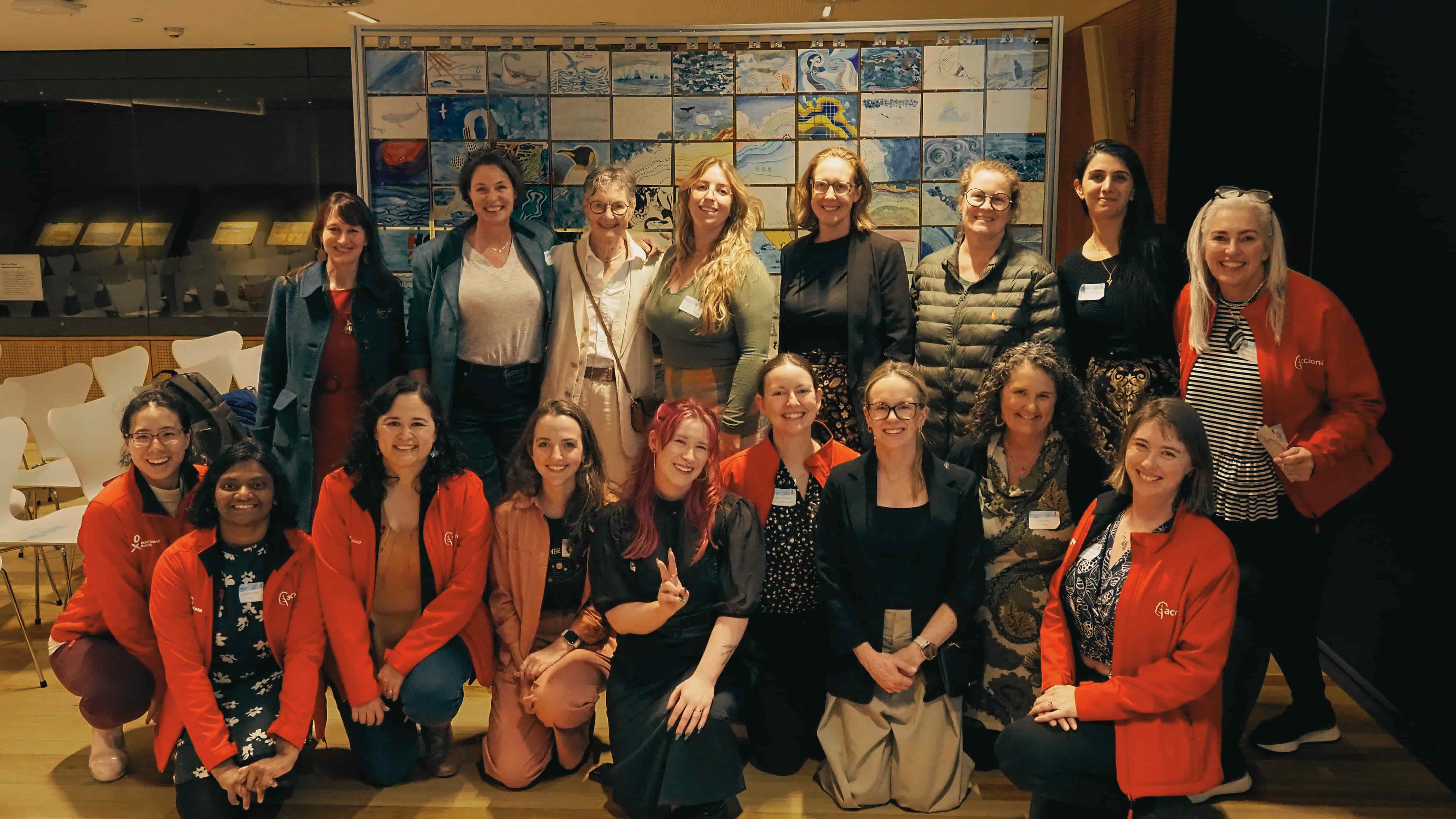 The team of researchers and artists behind the Postcards from Antarctica exhibit in front of the large-scale artwork. Photo: Cat Nielsen