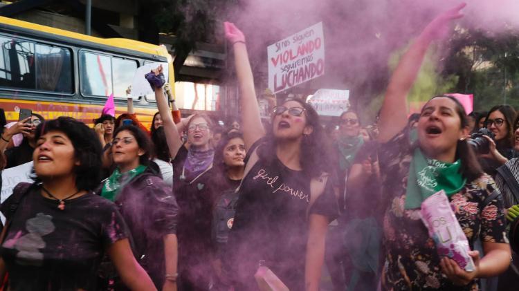 Women toss pink glitter during a protest march demanding justice and for their safety, sparked by two recent alleged rapes by police, in Mexico City, Friday, Aug. 16, 2019. (AP Photo/Marco Ugarte)