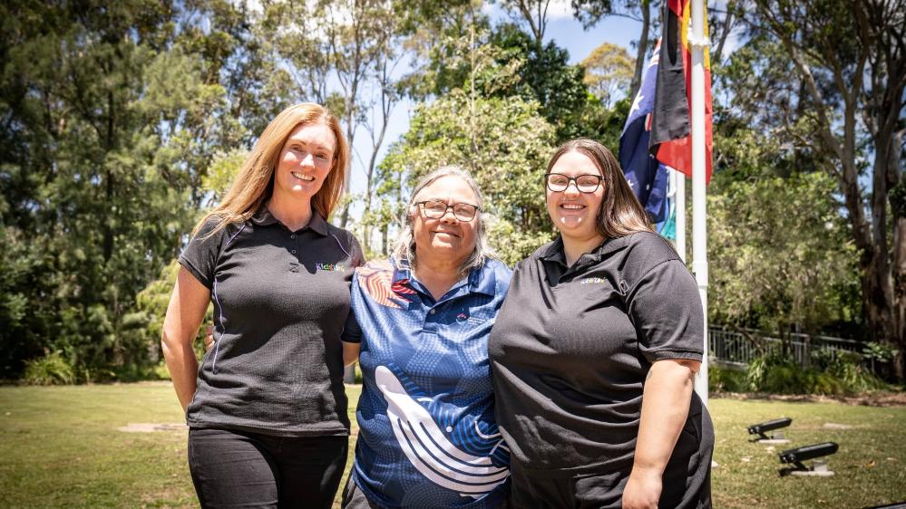 Kids Uni Director Kellie Grose, Aunty May, and Jordan Storm at the Aboriginal Flag raising at Wollongong Campus. Photo: Paul Jones