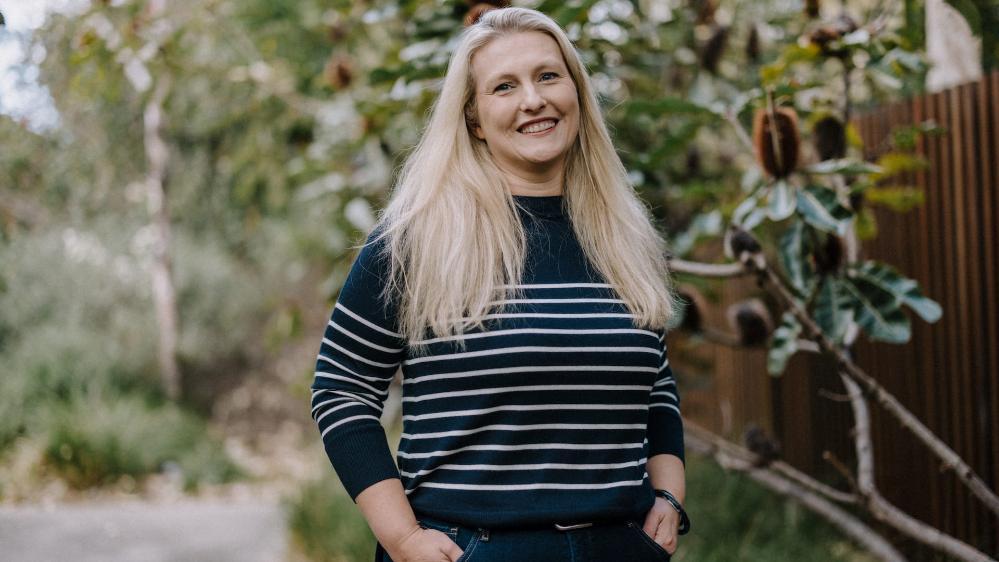 Early childhood educator Amy Taylor, wearing a striped jumper, smiles at the camera. Photo: Michael Gray
