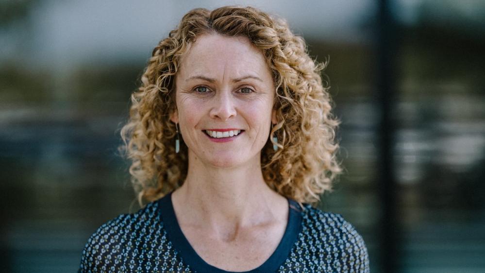 Dr Anna Farmery wears a blue jumper and smiles. She has curly blonde hair. Photo: Michael Gray