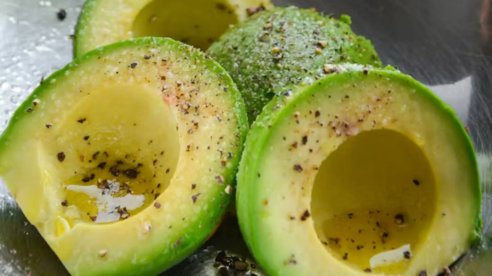 Avocado halves with salt and pepper