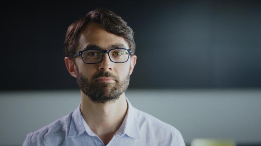 Ben Henley wears glasses and has a neutral look on his face. Photo: University of Melbourne