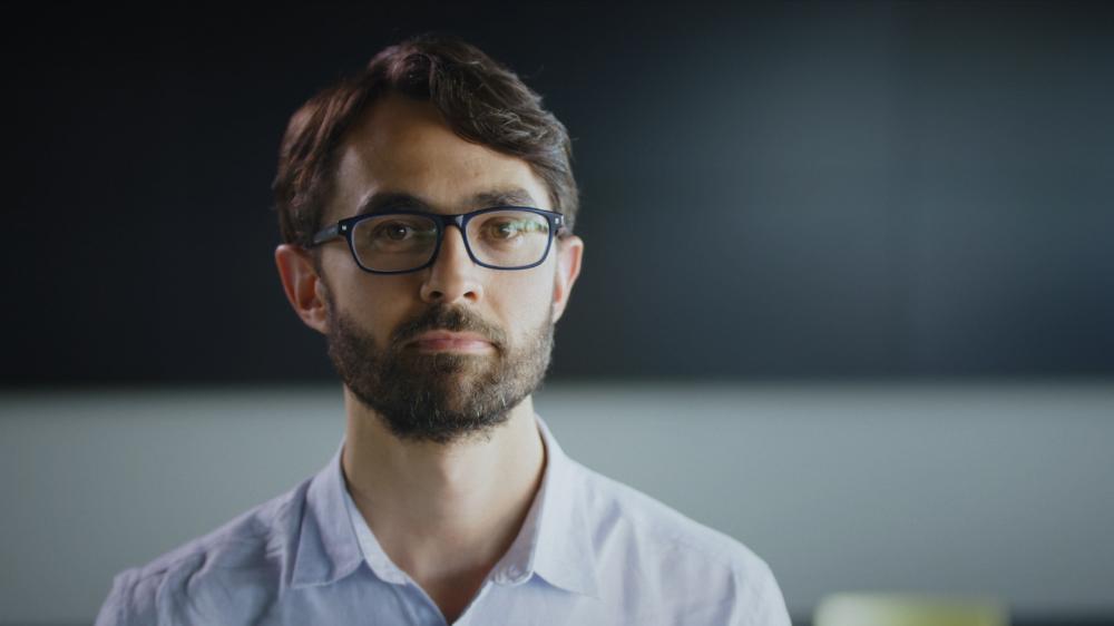 Ben Henley wears glasses and has a neutral look on his face. Photo: University of Melbourne