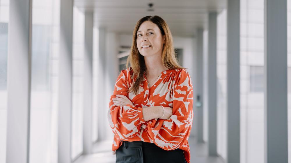 A woman stands in a hospital corridor with her arms folded. Photo: Michael Gray