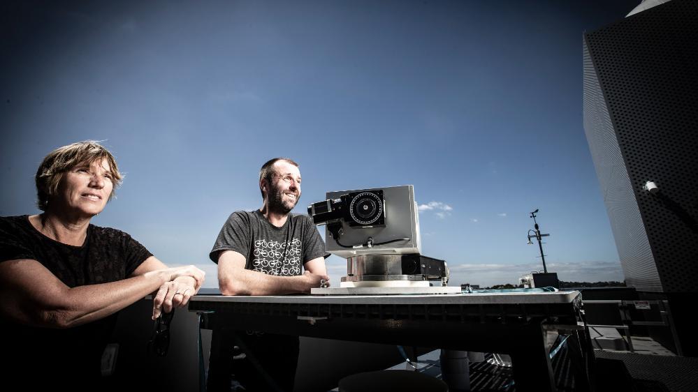 Professor Clare Murphy and Dr Nicholas Deutscher from the Centre for Atmospheric Chemistry, pictured on a rooftop at UOW. Photo: Paul Jones