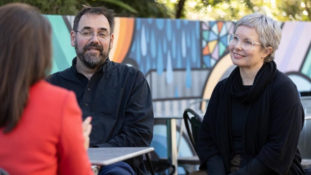 Researchers interviewing essential worker
