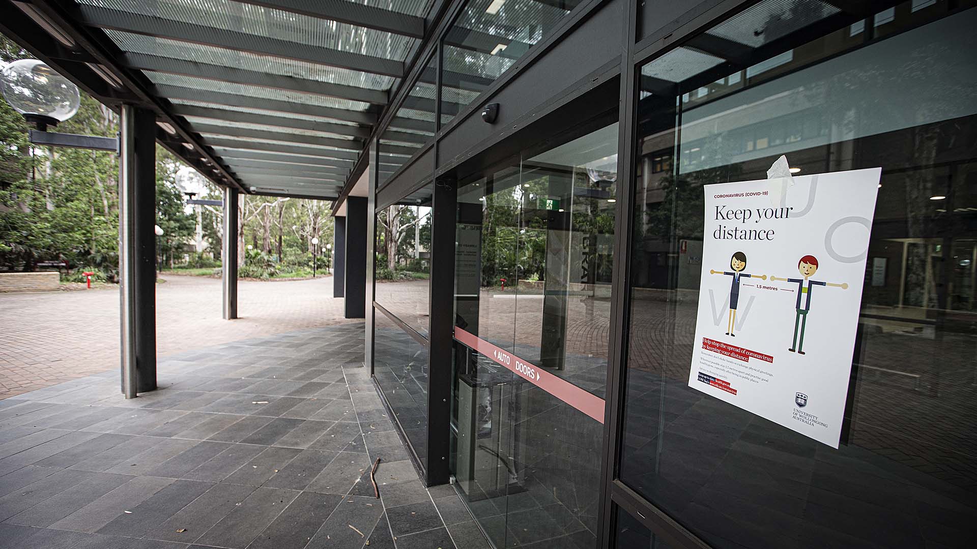 Signs outside the UOW Library asking people to maintain social ditance