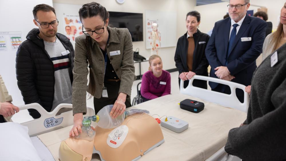 A woman performs CPR on a dummy during a tour of medical facilities. Photo: Mark Newsham