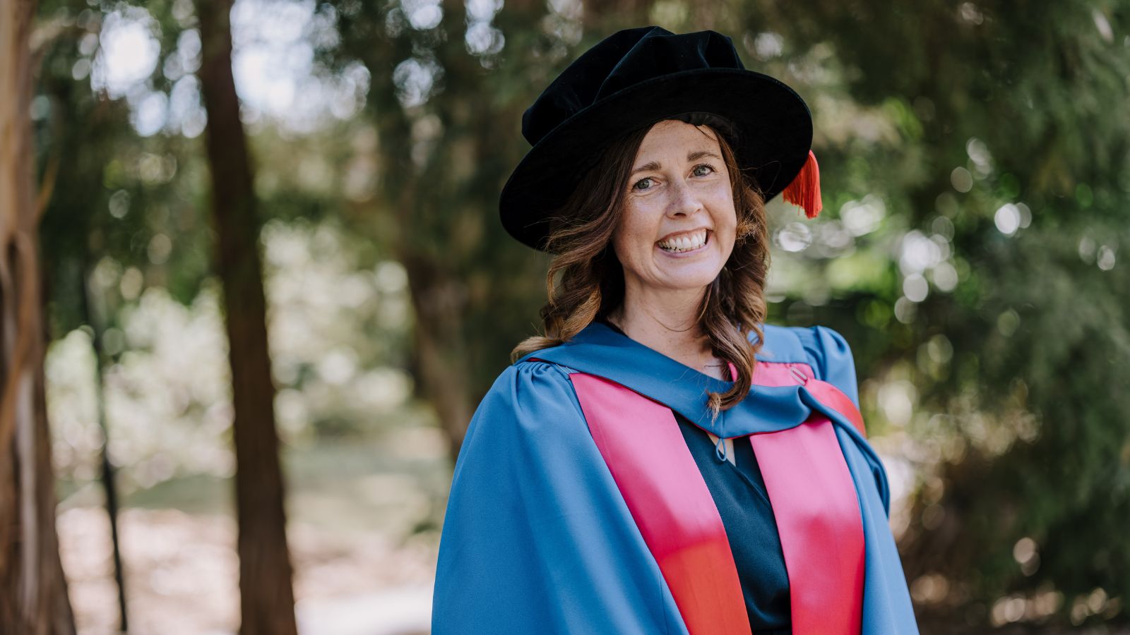 Dr Catherine Stephen smiles at the camera before the Faculty of Science, Medicine and Health Graduation Ceremony, October 2024