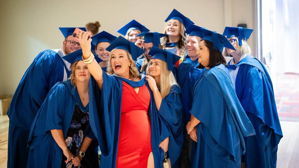 UOW Bega graduates pose for a selfie.