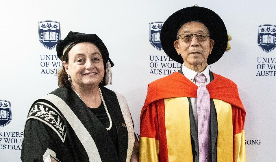 Professor Shi Xue Dou with Vice Chancellor Professor Patricia Davidson, both wearing graduation gowns and caps. Photo: Paul Jones