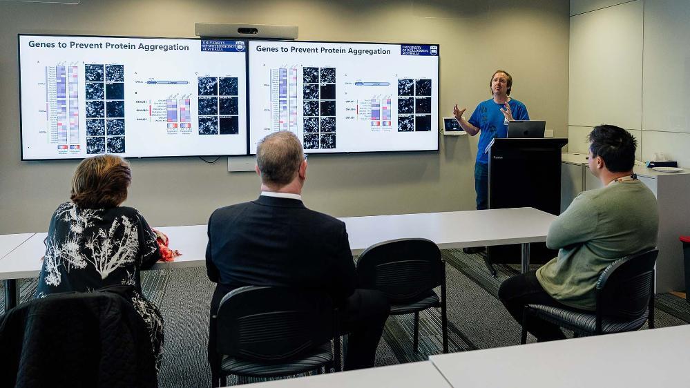 Bill Gole MND Postdoctoral Fellow Dr Luke McAlary gives Graham and his wife Catherine an update on MND research at UOW.