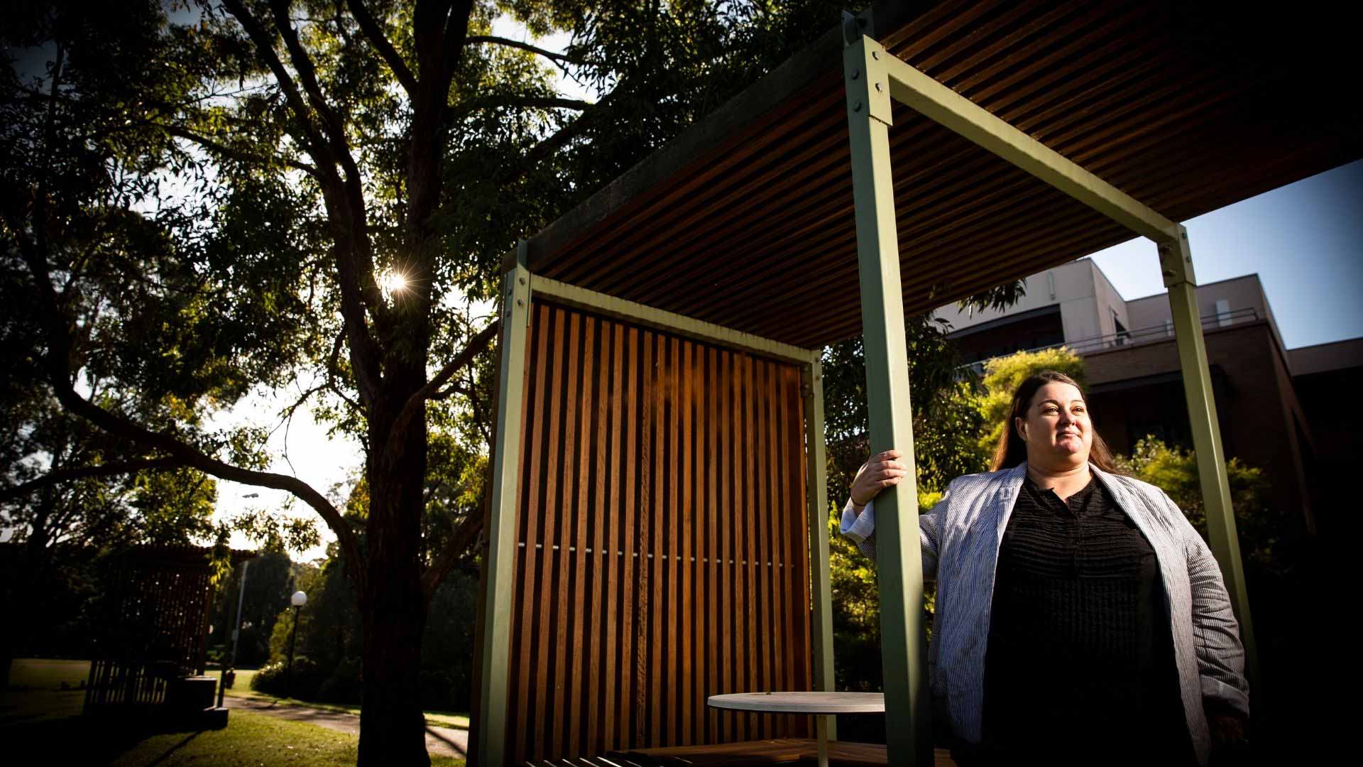 Heidi Green standing outside at Wollongong Campus with trees in the background. Photo: Paul Jones