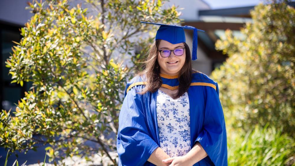 Master of Teaching graduate Jess Campbell smiles during the UOW Eurobodalla graduation ceremony. January 2025