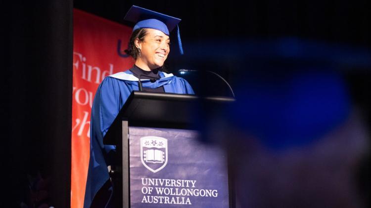 UOW graduate Loureene Kelly delivers a speech at the graduation at Bega Campus. Photo: Paul Jones