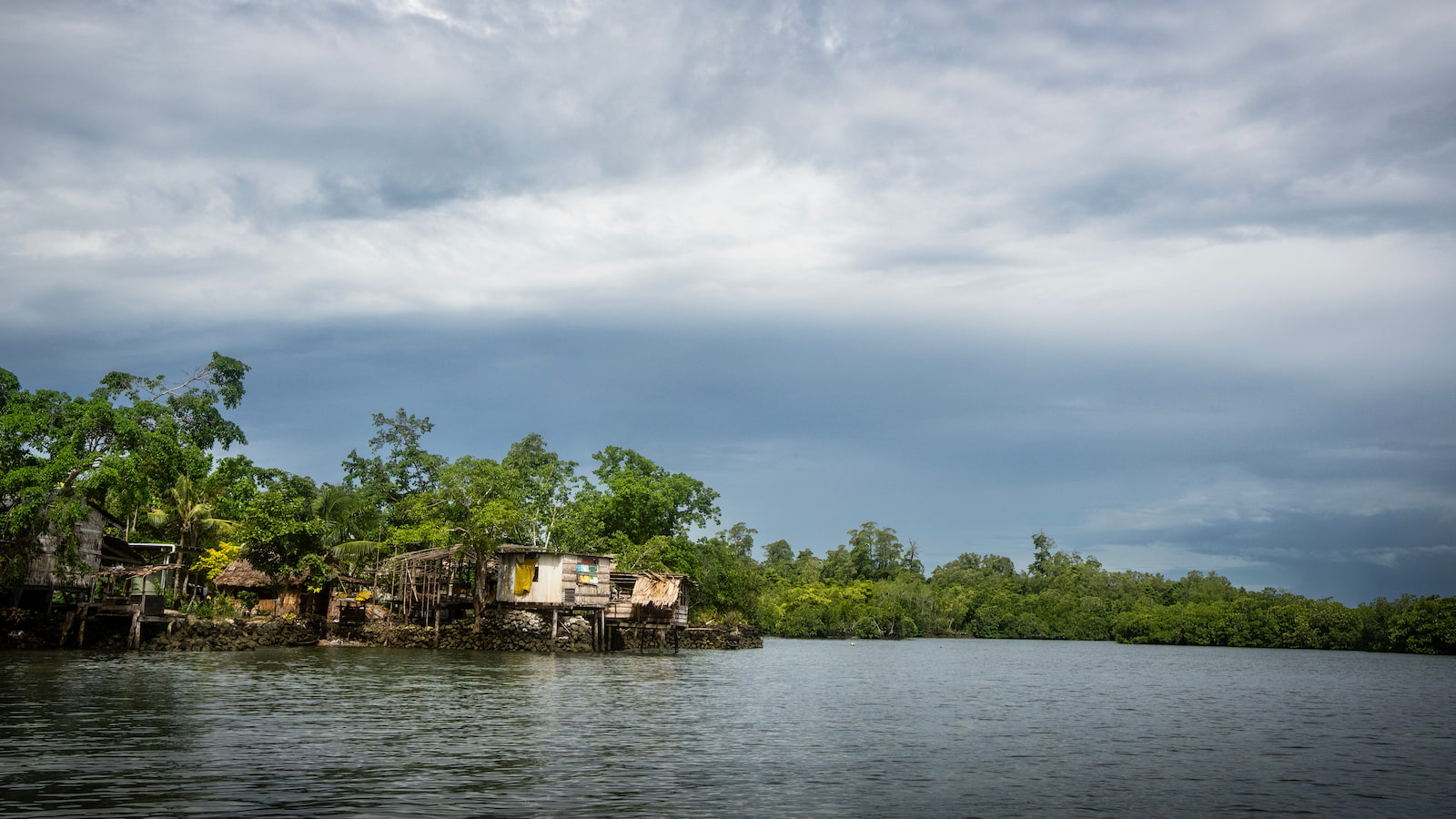 A village overlooking the ocean sits among a crop of mangroves in the Solomon Islands. Photo: Paul Jones