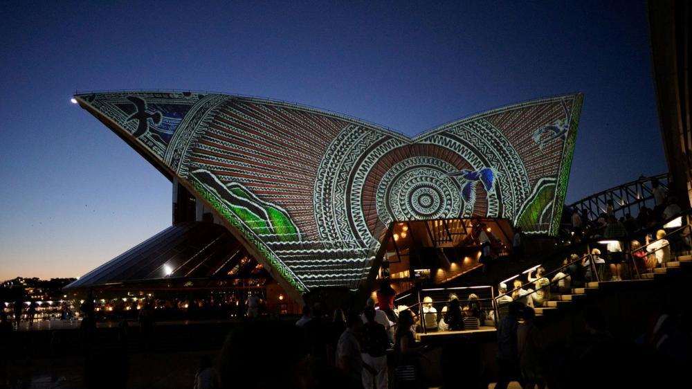 The Sydney Opera House at night time with Aboriginal artwork projected on the sails