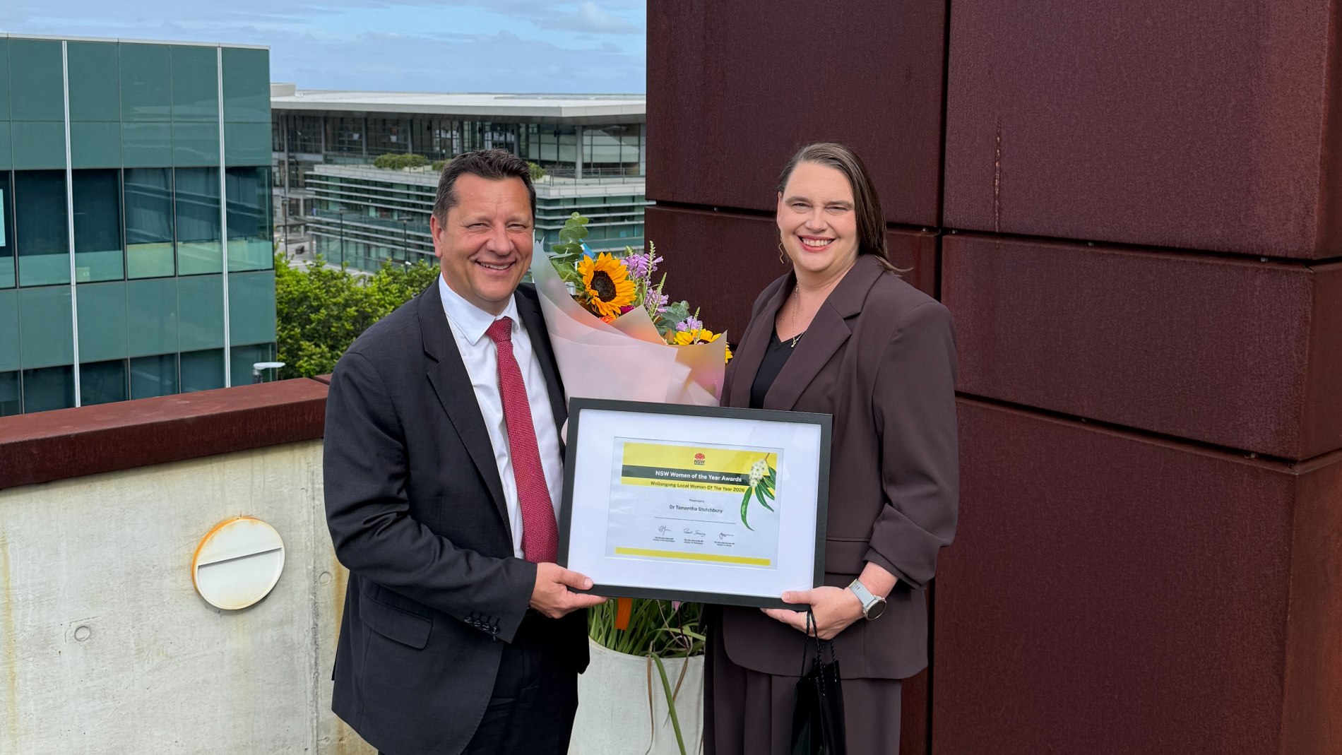 Paul Scully MP presenting Dr Tamantha Stutchbury with her 2026 Wollongong Woman of the Year award at iAccelerate. Photo: supplied