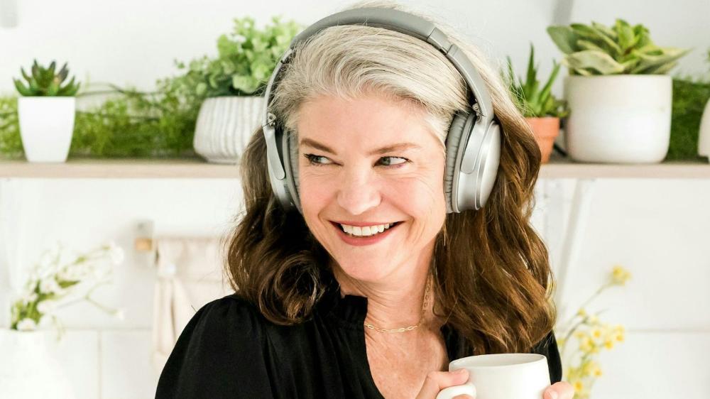 A woman smiling and wearing headphones