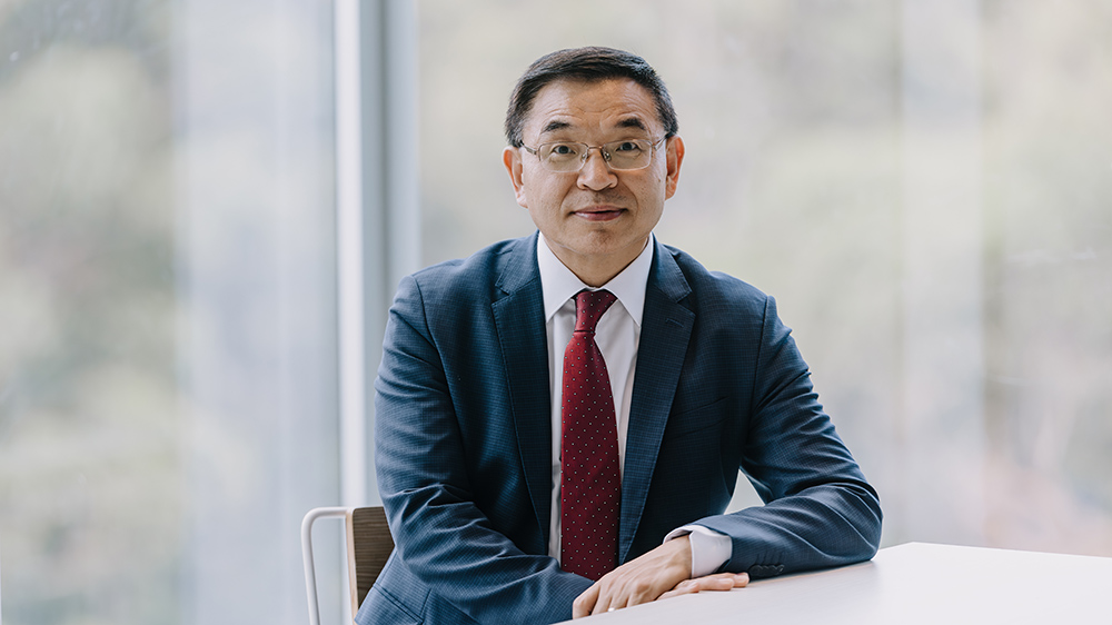 UOW Vice-Chancellor Professor Max Lu seated.