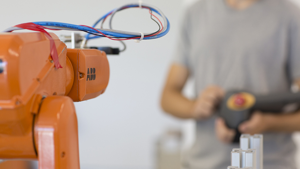 Researchers and students working with robotic devices