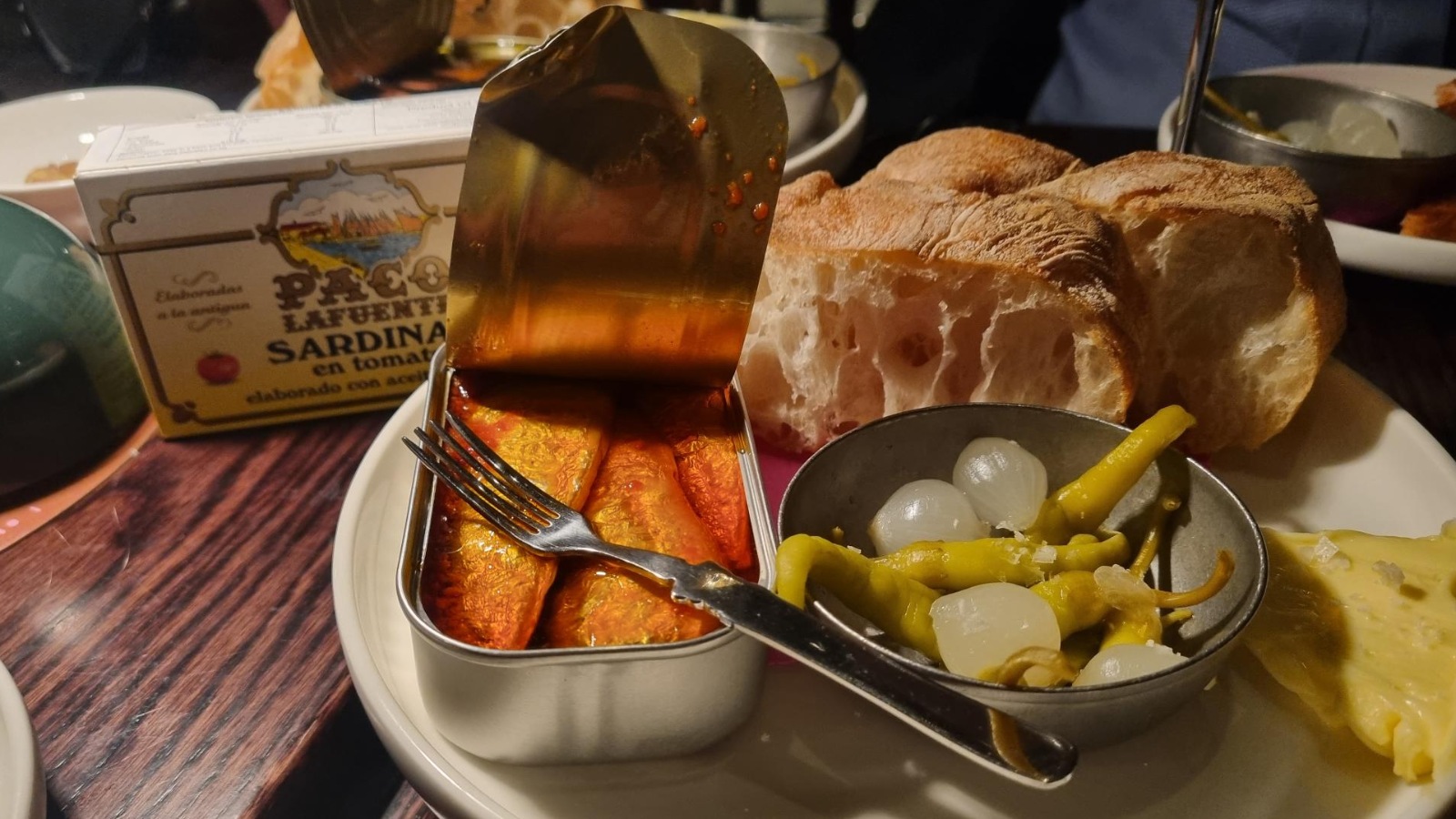 A dinner plate with an open can of sardines. Photo: Anna Farmery