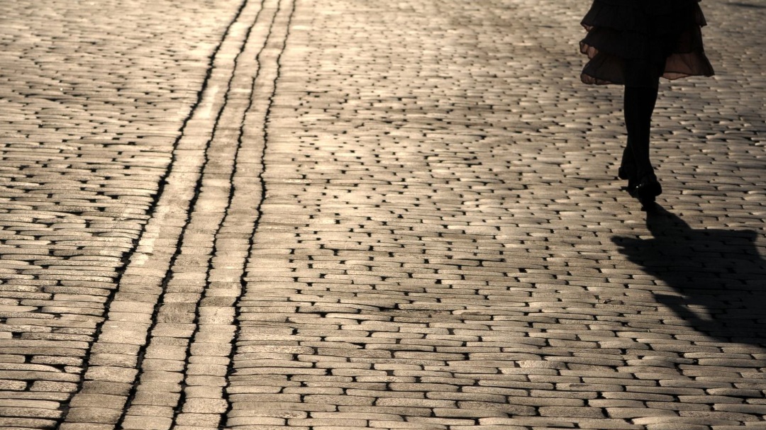 The fragment of a pavement. Silhouette of a girl. Credit: Shutterstock
