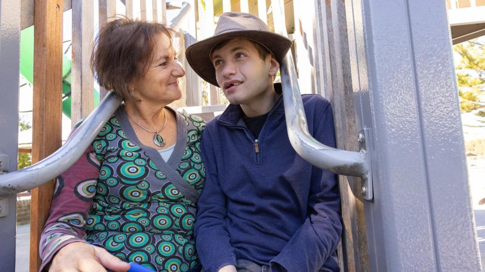Dr Shoshana Dreyfus sits with her son Bodhi on the stairs of playground equipment at North Wollongong. Shoshana is looking at Bodhi. Photo: Mark Newsham