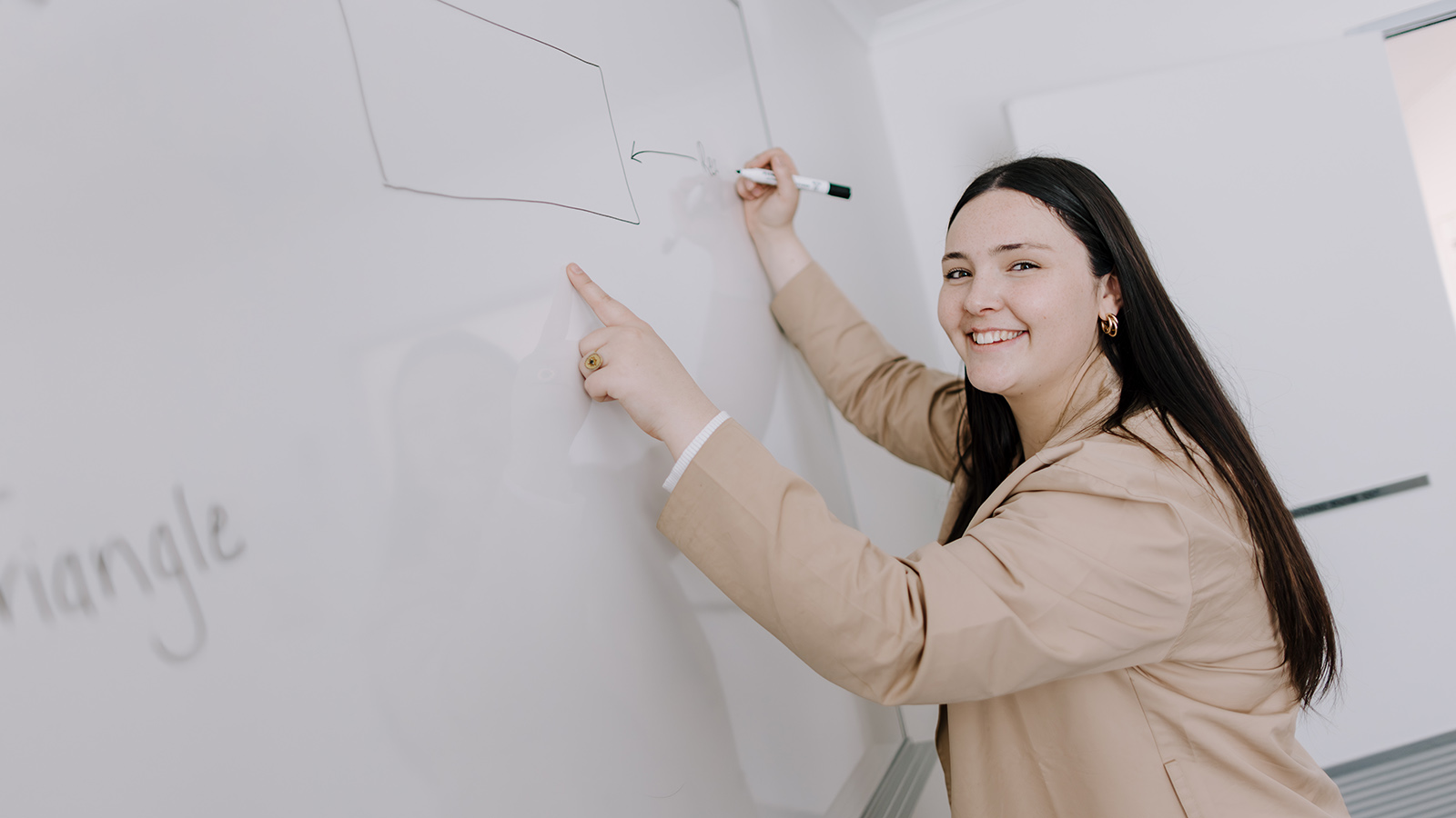 UOW primary teaching student Sophie Kearns at a whiteboard.