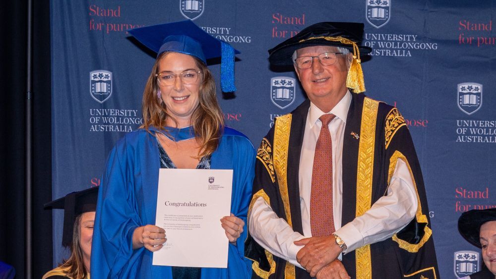 UOW Bega nursing graduate Stephanie Burton holding her certificate at the UOW Bega Graduation ceremony.